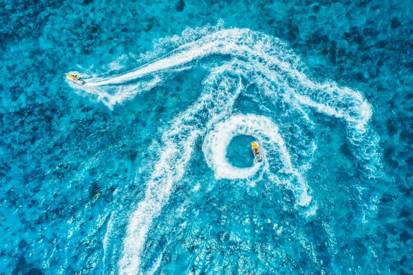 Aerial view of floating water scooter in blue water at sunset